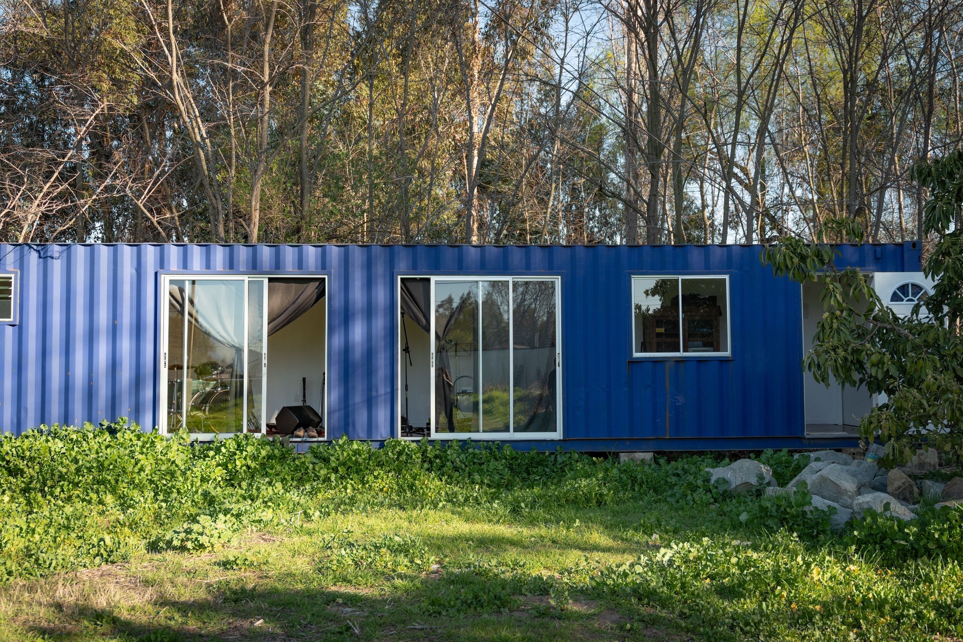 Minimalistic shipping container house home, tiny house in sunny day. Shipping container houses is sustainable, eco-friendly living accommodation or holiday home